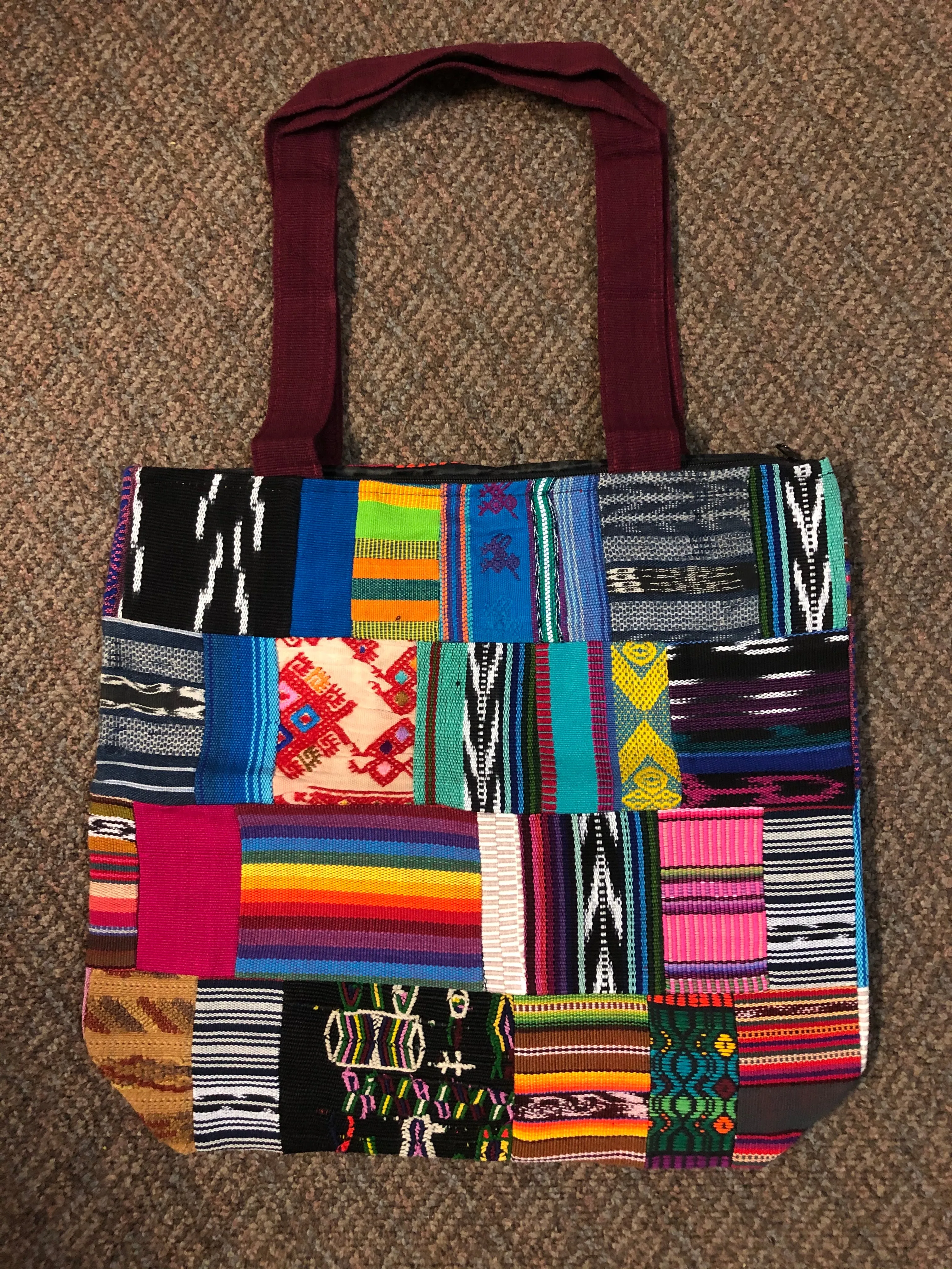 Handwoven Guatemalan cotton patches fashioned into a sturdy shoulder bag, fully lined with one zipper pocket. 15” x 17”