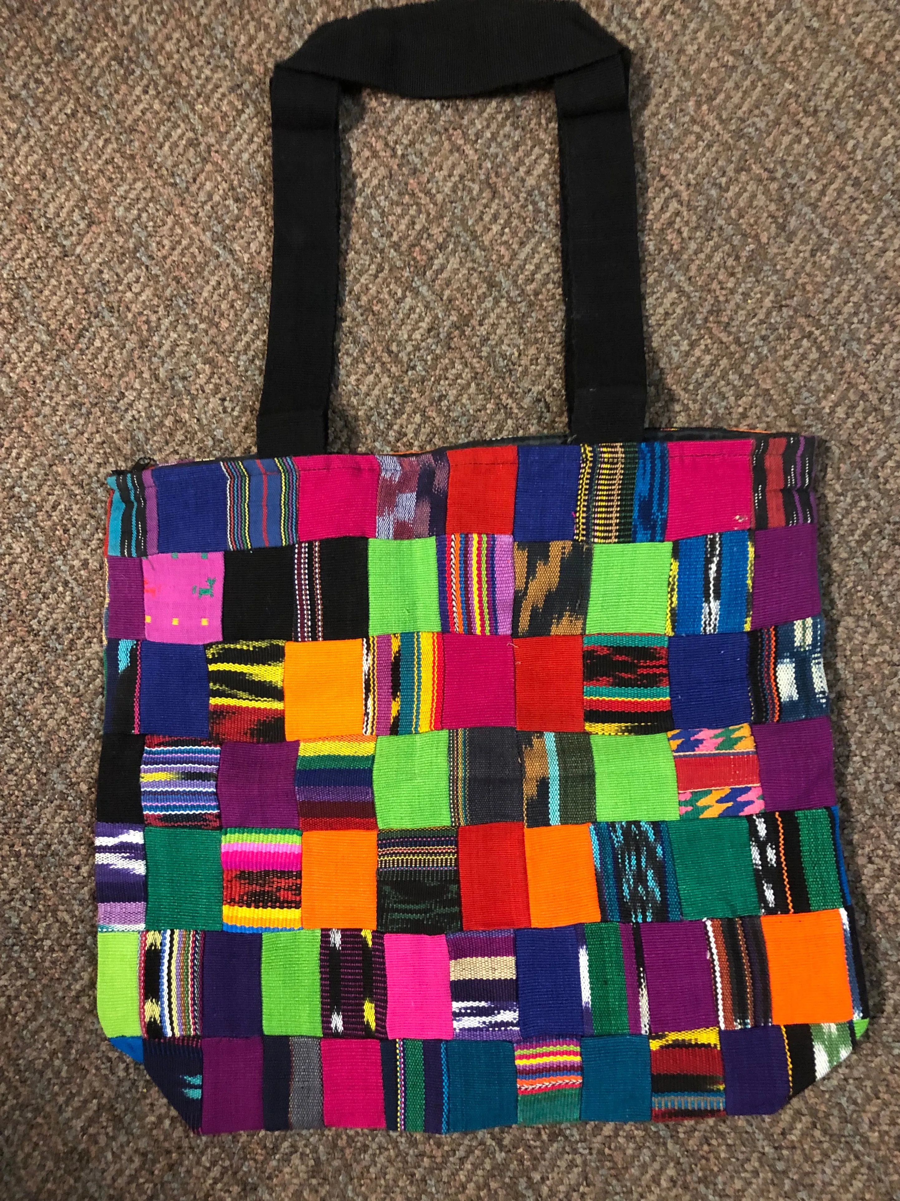 Handwoven Guatemalan cotton patches fashioned into a sturdy shoulder bag, fully lined with one zipper pocket. 15” x 17”