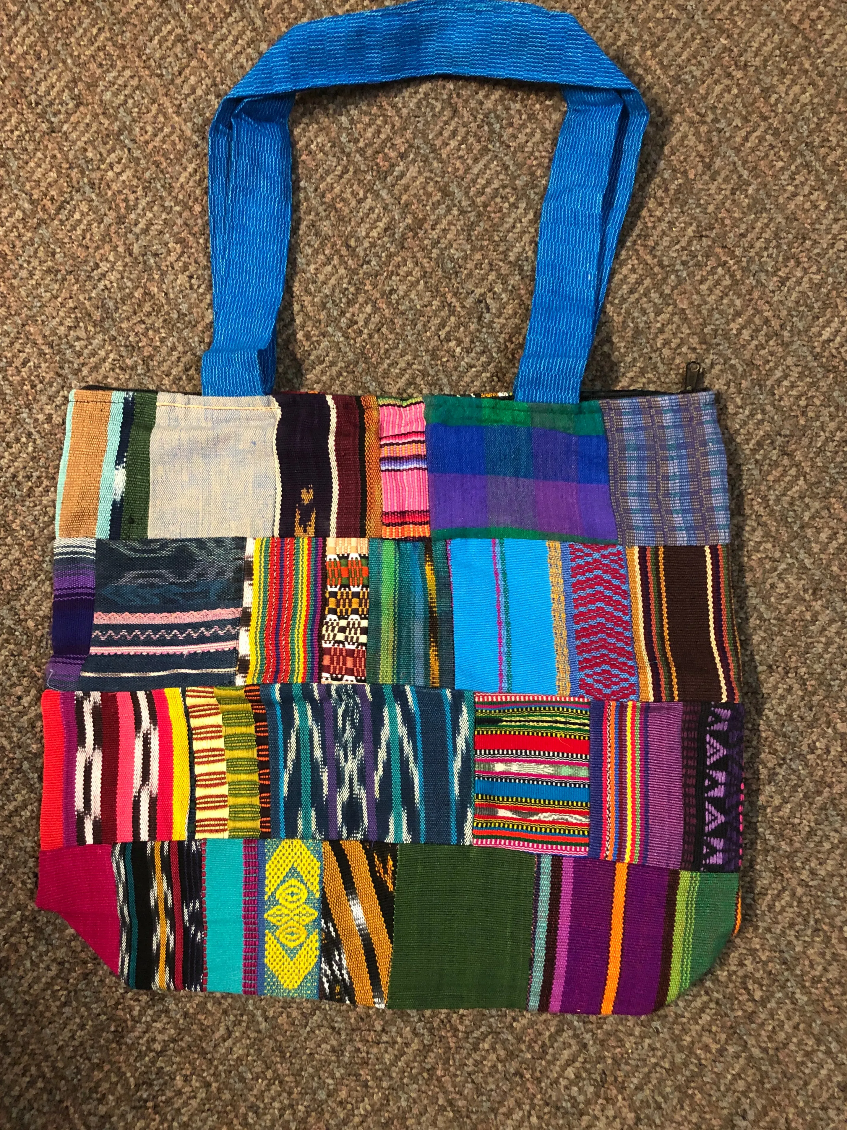 Handwoven Guatemalan cotton patches fashioned into a sturdy shoulder bag, fully lined with one zipper pocket. 15” x 17”